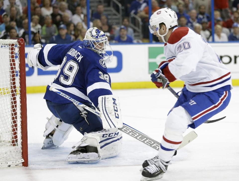 Tampa Bay Lightning goalie Anders Lindback (39), of Sweden, cuts back but cannot stop Montreal Canadiens left wing Thomas Vanek (20), of Austria, from scoring during the third period of Game 1 of a first-round NHL hockey playoff series on Wednesday, April 16, 2014, in Tampa, Fla. (AP Photo/Chris O'Meara)