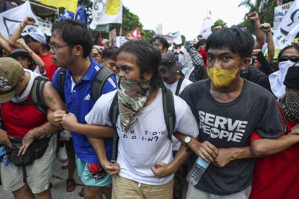 Filipino activists march towards the U.S. Embassy during a protest to mark International Labor Day in Manila, Philippines on Wednesday, May 1, 2024. Hundreds of Filipino workers from various labor groups took to the streets to mark Labor Day and demand a wage increase and job security amid soaring food and oil prices. (AP Photo/Basilio Sepe)