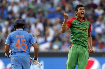 Bangladesh's Taskin Ahmed reacts after bowling out India's batsman Rohit Sharma during their Cricket World Cup quarter-final match in Melbourne, March 19, 2015. REUTERS/Brandon Malone