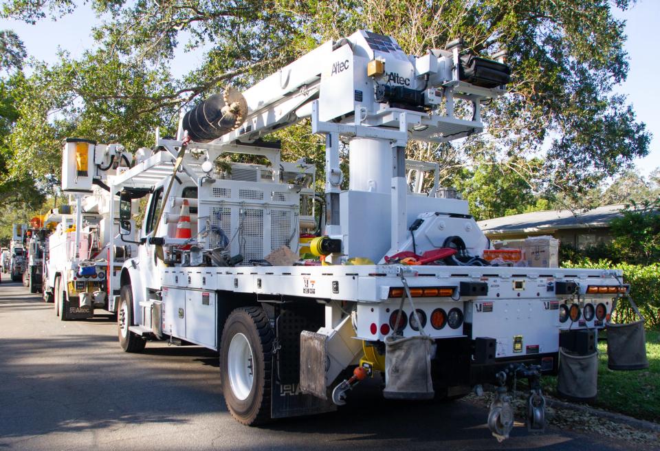 A line of trucks is parked along Bristol Avenue on Tuesday morning as crews restore power to some of the final houses still affected by outages from Hurricane Ian.