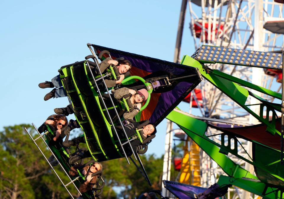 Hold on tight! People on the midway enjoy the rides at the Volusia County Fair during opening night, Thursday, Nov. 2, 2023, at the fairgrounds in DeLand. The annual fair runs through Nov. 12.