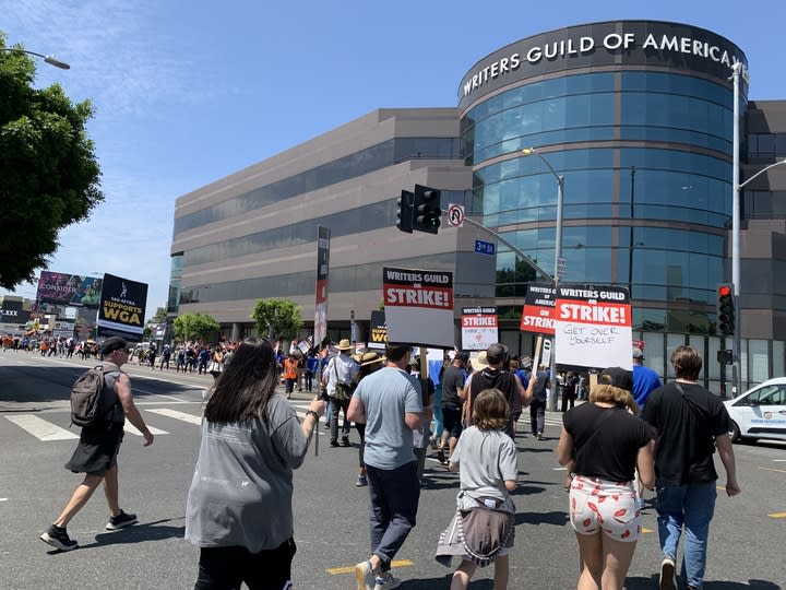Supporters walk past WGA West headquarters.