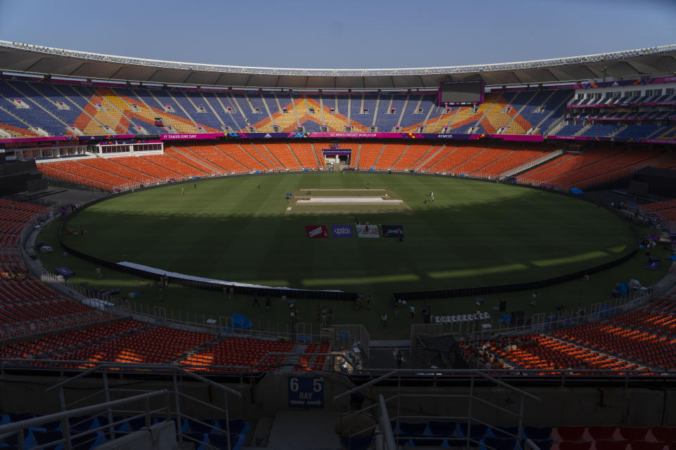 Grounds men work on the pitch inside the Narendra Modi stadium ahead of the ICC cricket world cup Ahmedabad, India, Tuesday, Oct. 3, 2023. (AP Photo/Rafiq Maqbool)