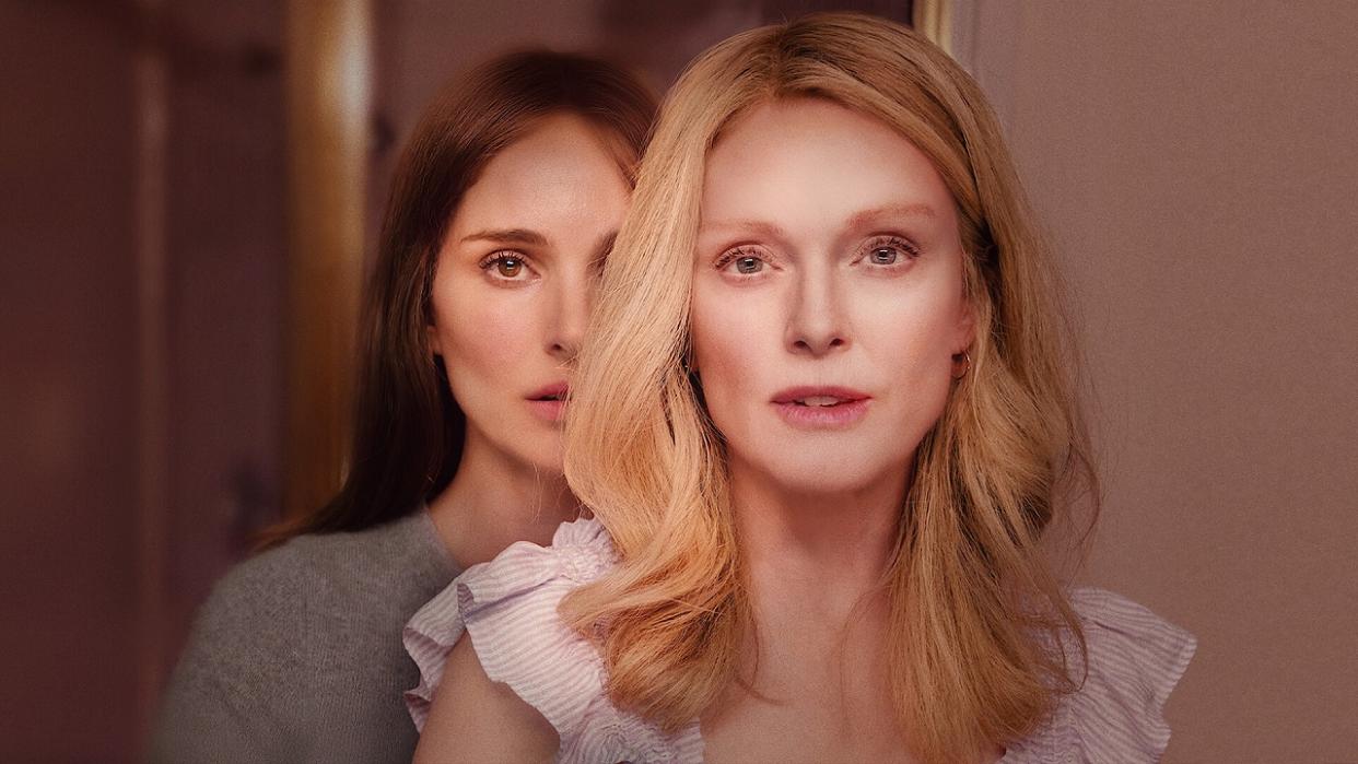  Natalie Portman standing behind Julianne Moore in a promotional image from Oscar-nominated movie May December. 