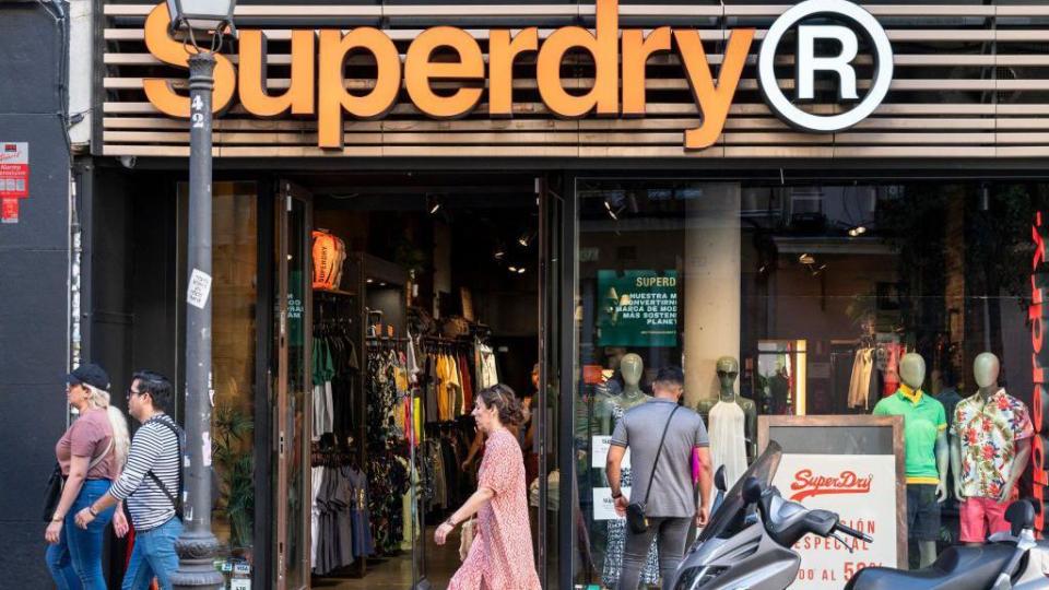 Shoppers walking by Superdry store