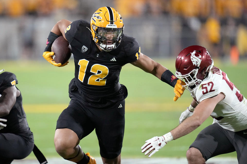 Arizona State tight end Jalin Conyers (12) runs with the ball as Washington State linebacker Kyle Thornton (52) tries to make a tackle during the first half of an NCAA college football game Saturday, Oct. 28, 2023, in Tempe, Ariz. (AP Photo/Ross D. Franklin)