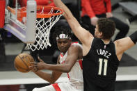 Houston Rockets' Danuel House Jr. (4) passes the ball around Milwaukee Bucks' Brook Lopez (11) during the first half of an NBA basketball game Friday, May 7, 2021, in Milwaukee. (AP Photo/Aaron Gash)