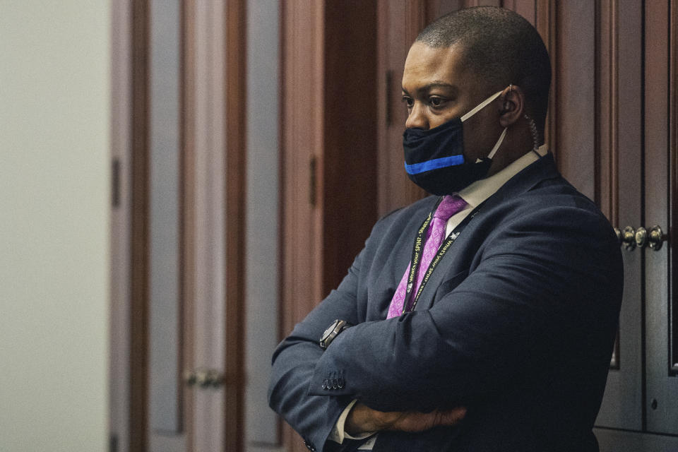 U.S. Capitol Police officer Eugene Goodman watches never-before-seen security footage of rioters storming the Capitol on Jan. 6, during the second day of former President Donald Trump's second impeachment trial, Wednesday, Feb. 10, 2021 in the Capitol in Washington. Goodman, who has been lauded as a hero, warned Sen. Mitt Romney, R-Utah, the rioters were headed his way. Goodman also directed the mob away from the Senate door and the Chamber, and toward other officers. (Brandon Bell/The New York Times via AP, Pool)