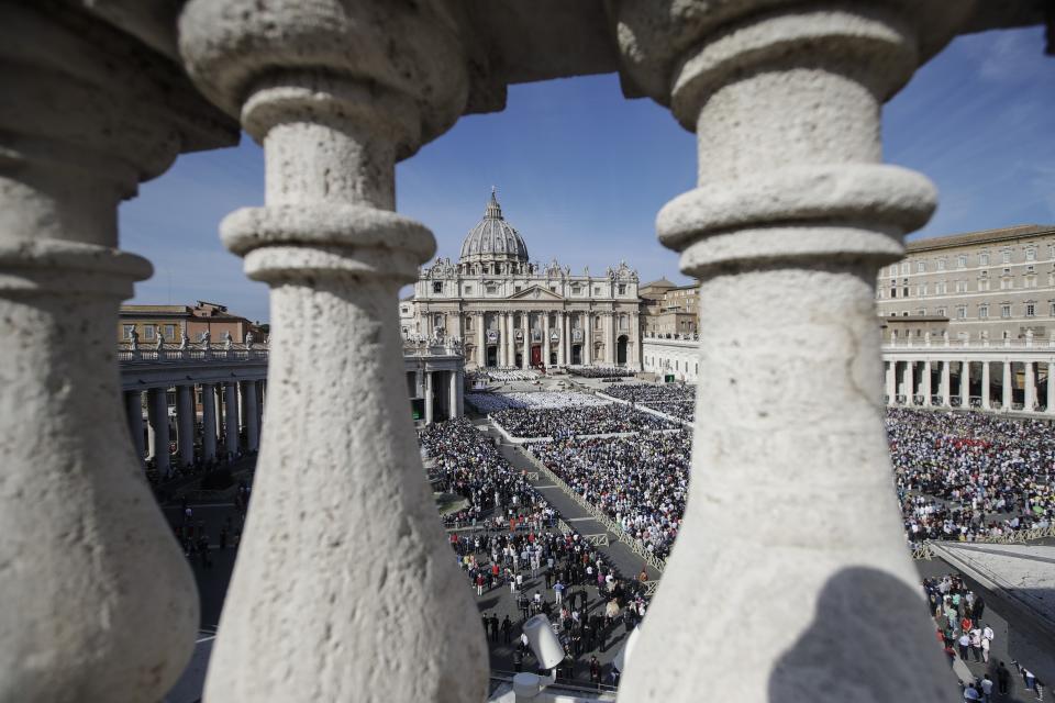 Faithful gather in St. Peter's Square at the Vatican, Sunday, Oct. 13, 2019. Pope Francis on Sunday canonized Cardinal John Henry Newman, the 19th-century Anglican convert who became an immensely influential, unifying figure in both the Anglican and Catholic churches. Francis presided over Mass on Sunday in a packed St. Peter's Square to declare Newman and four women saints. (AP Photo/Alessandra Tarantino)