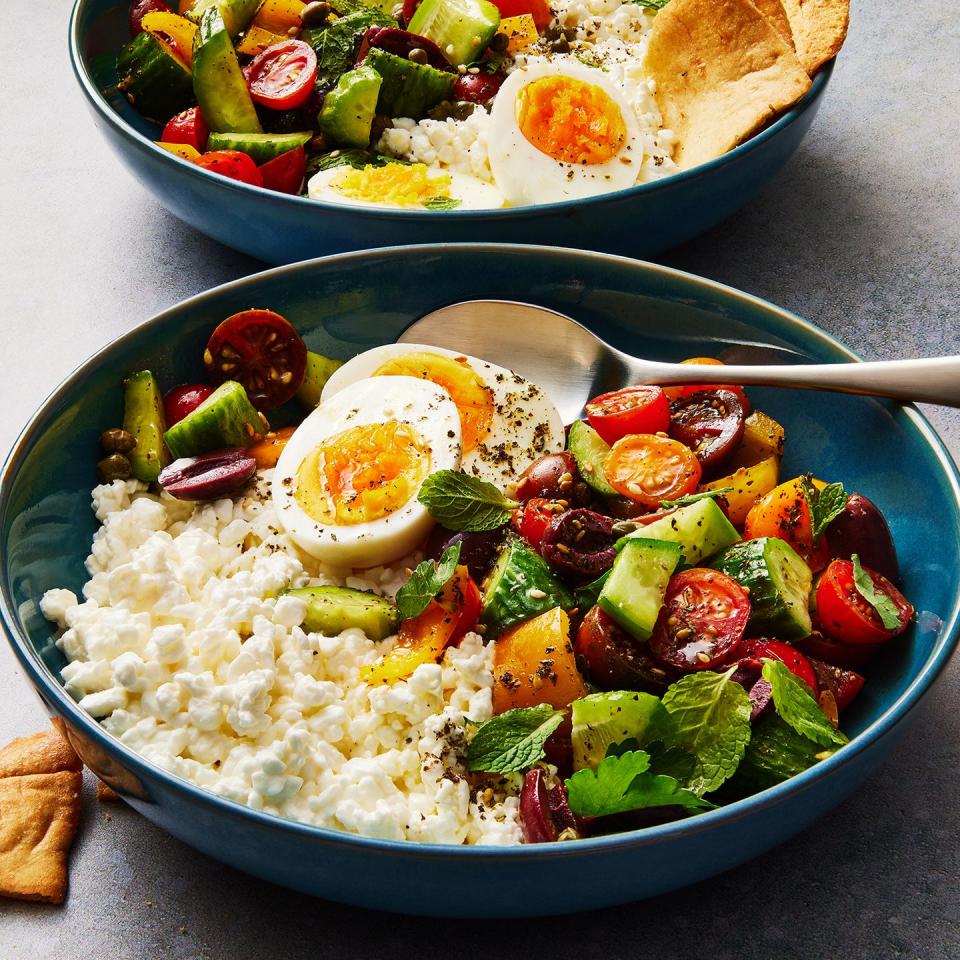 cottage cheese, soft boiled eggs, and a cucumber tomato salad topped with pita chips