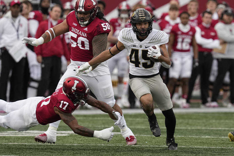 Purdue's Devin Mockobee (45) runs past Indiana's Jonathan Haynes (17) during the first half of an NCAA college football game, Saturday, Nov. 26, 2022, in Bloomington, Ind. (AP Photo/Darron Cummings)