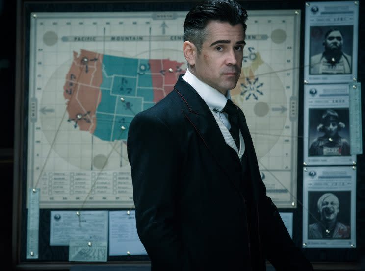 MACUSA director Percival Graves stands before a map of the most wanted wizards (Photo: Warner Bros.)