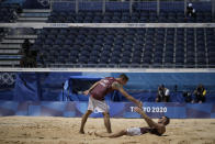 Martins Plavins, center, of Latvia, celebrates with teammate Edgars Tocs, after winning a men's beach volleyball quarterfinal match against Brazil at the 2020 Summer Olympics, Wednesday, Aug. 4, 2021, in Tokyo, Japan. (AP Photo/Felipe Dana)