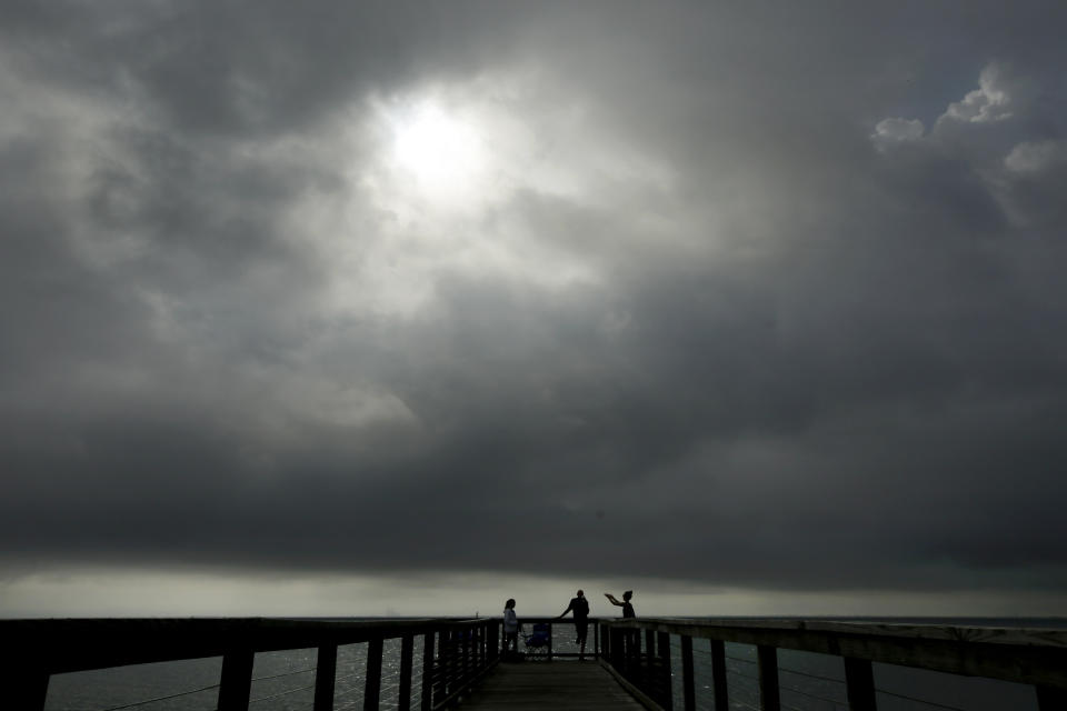 Spectators wait in a Titusville, Fla. park for the launch of SpaceX Falcon 9 with NASA astronauts Doug Hurley and Bob Behnken in the Dragon crew capsule, Wednesday, May 27, 2020, from the Kennedy Space Center at Cape Canaveral, Fla. The two astronauts will travel on the SpaceX test flight to the International Space Station. For the first time in nearly a decade, astronauts will travel to space aboard an American rocket from American soil, a first for a private company. (AP Photo/Charlie Riedel)