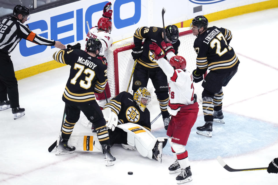 Boston Bruins goaltender Jeremy Swayman (1) sits on the ice as Carolina Hurricanes center Jake Guentzel (59) celebrates after scoring during the third period of an NHL hockey game, Tuesday, April 9, 2024, in Boston. (AP Photo/Charles Krupa)