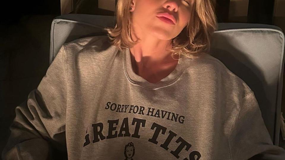 Sydney Sweeney wearing a sweater with the slogan "sorry for having great tits"
