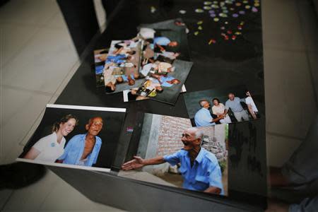 Pictures of Liu Guolian's father Liu Qian, who was a forced labourer by Mitsui Mining to work in their mines in Fukuoka of Japan, are seen on a table during an interview with Reuters on the outskirts of Beijing, April 28, 2014. REUTERS/Petar Kujundzic