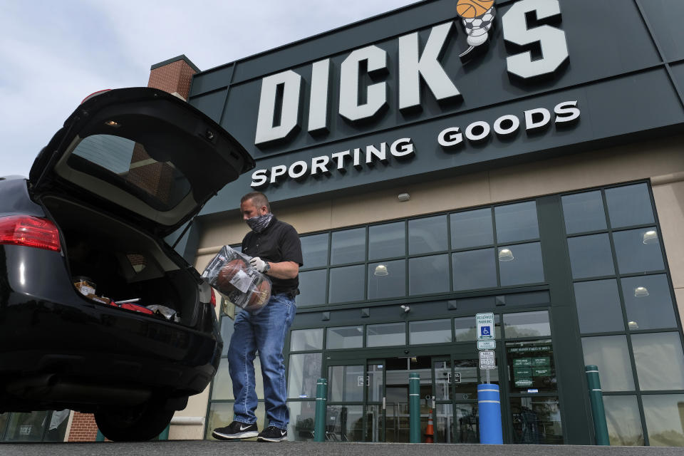 FILE - Gus Promollo puts an order in a customer's trunk at Dick's Sporting Goods on May 18, 2020, in Paramus, N.J. Dick's Sporting Goods profit slipped in its second quarter and missed Wall Street's expectations as the retailer cut its full-year profit outlook, citing worries over theft at its stores. (AP Photo/Seth Wenig, File)