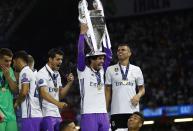 <p>Real Madrid’s Isco celebrates with the trophy after winning the UEFA Champions League Final </p>