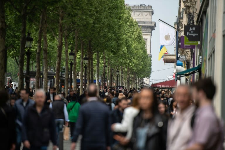 Des personnes marchent sur l'avenue des Champs-Elysées, le 29 avril 2022 (AFP/-)