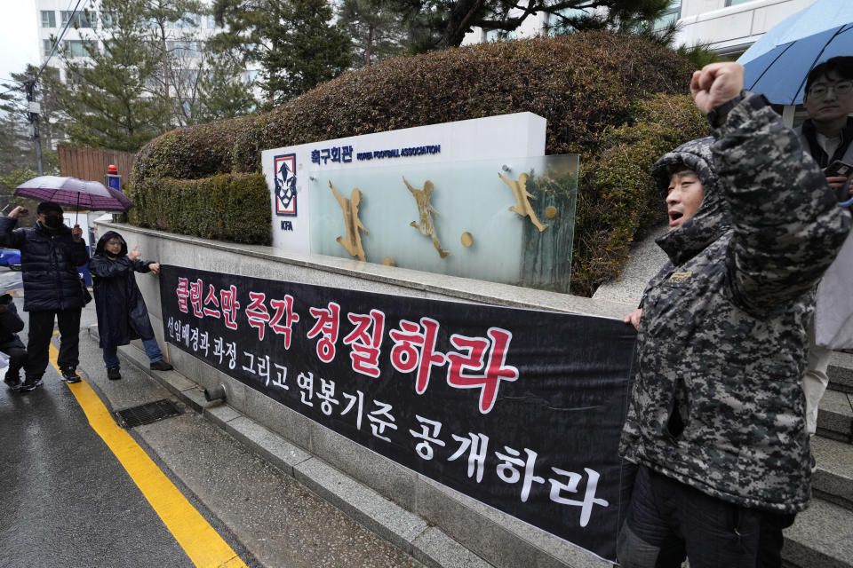 Soccer fans unfurl a banner demanding the dismissal of the South Korean men's football head coach Jurgen Klinsmann in front of the headquarters of the Korean Football Association (KFA) in Seoul, South Korea, Thursday, Feb. 15, 2024. KFA officials have recommended Klinsmann be fired after an Asian Cup semifinal exit and reports of infighting among star players. The banner reads "Fire Klinsmann Immediately." (AP Photo/Ahn Young-joon)