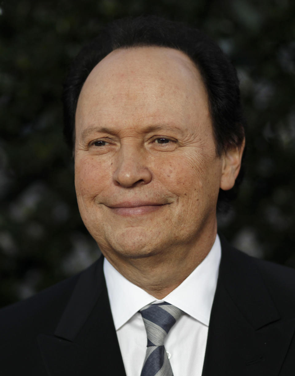 FILE - In this May 4, 2011 file photo, Billy Crystal arrives at The Academy of Motion Picture Arts and Sciences Tribute honoring Sophia Loren in Beverly Hills, Calif. Crystal returns as host for the 84th Academy Awards on Sunday, Feb. 26, 2012. (AP Photo/Matt Sayles, file)