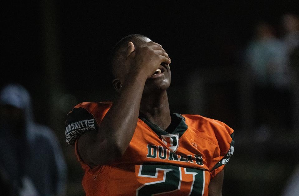 Kelby Tyre of Dunbar reacts to their loss to Mainland in the state football semifinals on Friday, Dec. 2, 2022, in Fort Myers.