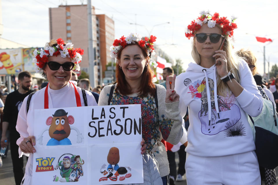 Women with a wreath on their heads pose for a photo during a Belarusian opposition supporters' rally protesting the official presidential election results in Minsk, Belarus, Sunday, Sept. 13, 2020. Protests calling for the Belarusian president's resignation have broken out daily since the Aug. 9 presidential election that officials say handed him a sixth term in office. (TUT.by via AP)