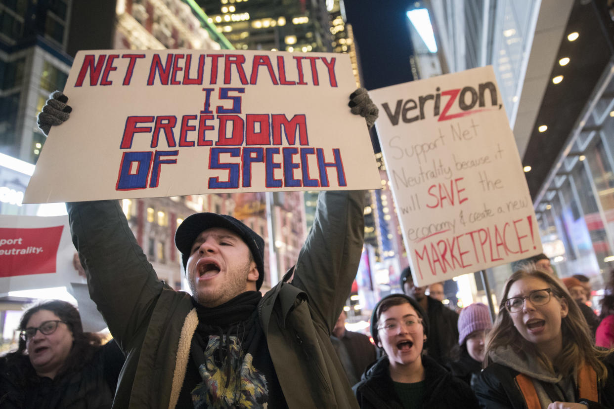 FILE - In this Thursday, Dec. 7, 2017, file photo, demonstrators rally in support of net neutrality outside a Verizon store in New York.  (AP Photo/Mary Altaffer, File)
