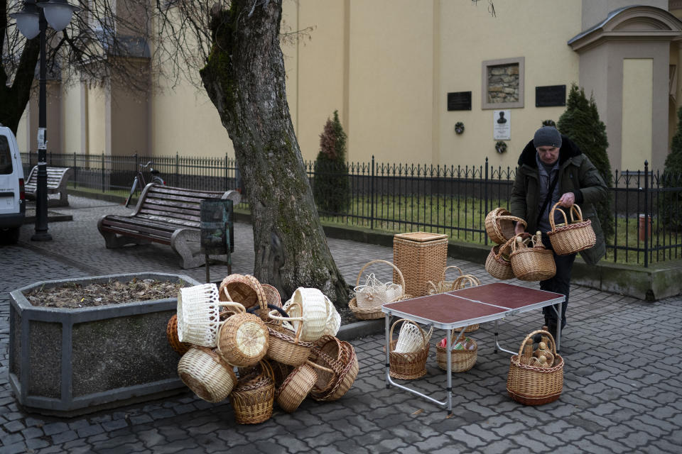 A basket vendor, member of Ukraine's ethnic Hungarian minority, packs his goods after the market closed in Berehevo on Saturday, Jan. 27, 2024. Ukraine amended its laws to comply with EU membership requirements, and restored many of the language rights for minorities demanded by Budapest but Hungary's government has indicated it is not fully satisfied — a potentially explosive sticking point as EU leaders meet Thursday Feb. 1, 2024 to try and break Orban's veto of a major aid package earmarked for Kyiv. (AP Photo/Denes Erdos)