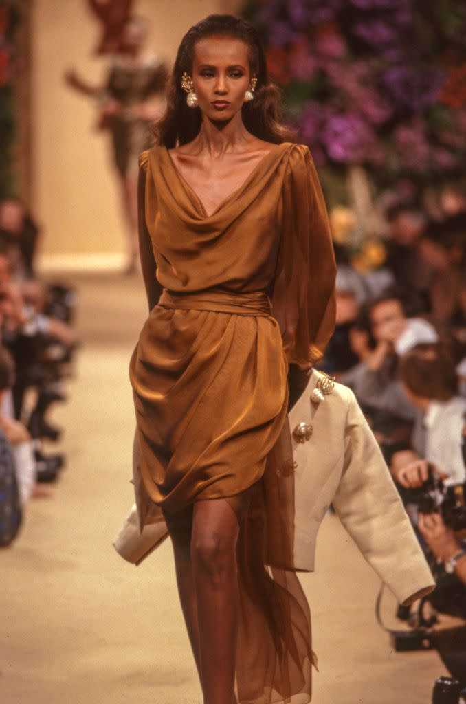 <p>And last but not least, Iman wore this draped brown Yves Saint Laurent number for the 1989 collection, working the runway as only Iman can.</p>