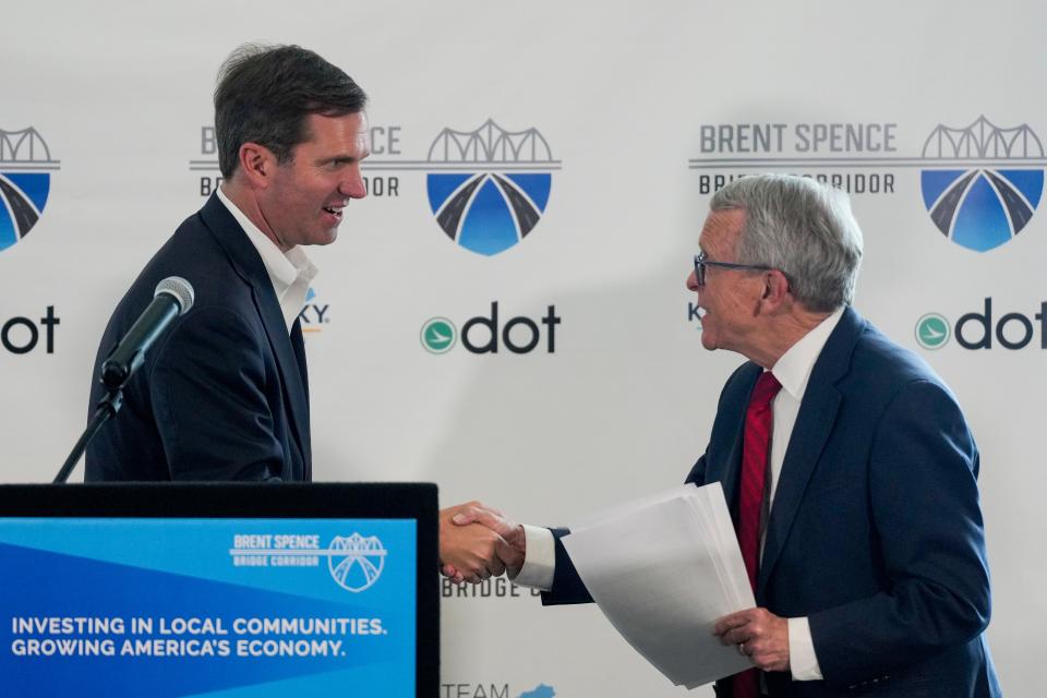 Kentucky and Ohio governors Andy Beshear (left) and Mike DeWine shake hands during a press conference to announce the contracting team that will build and design the $3.6 billion Brent Spence Bridge Corridor Project.