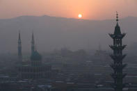 The sun rises over mountains and mosques in China's Linxia, Gansu province, home to a large population of ethnic minority Hui Muslims, February 3, 2018. Picture taken February 3, 2018. REUTERS/Michael Martina