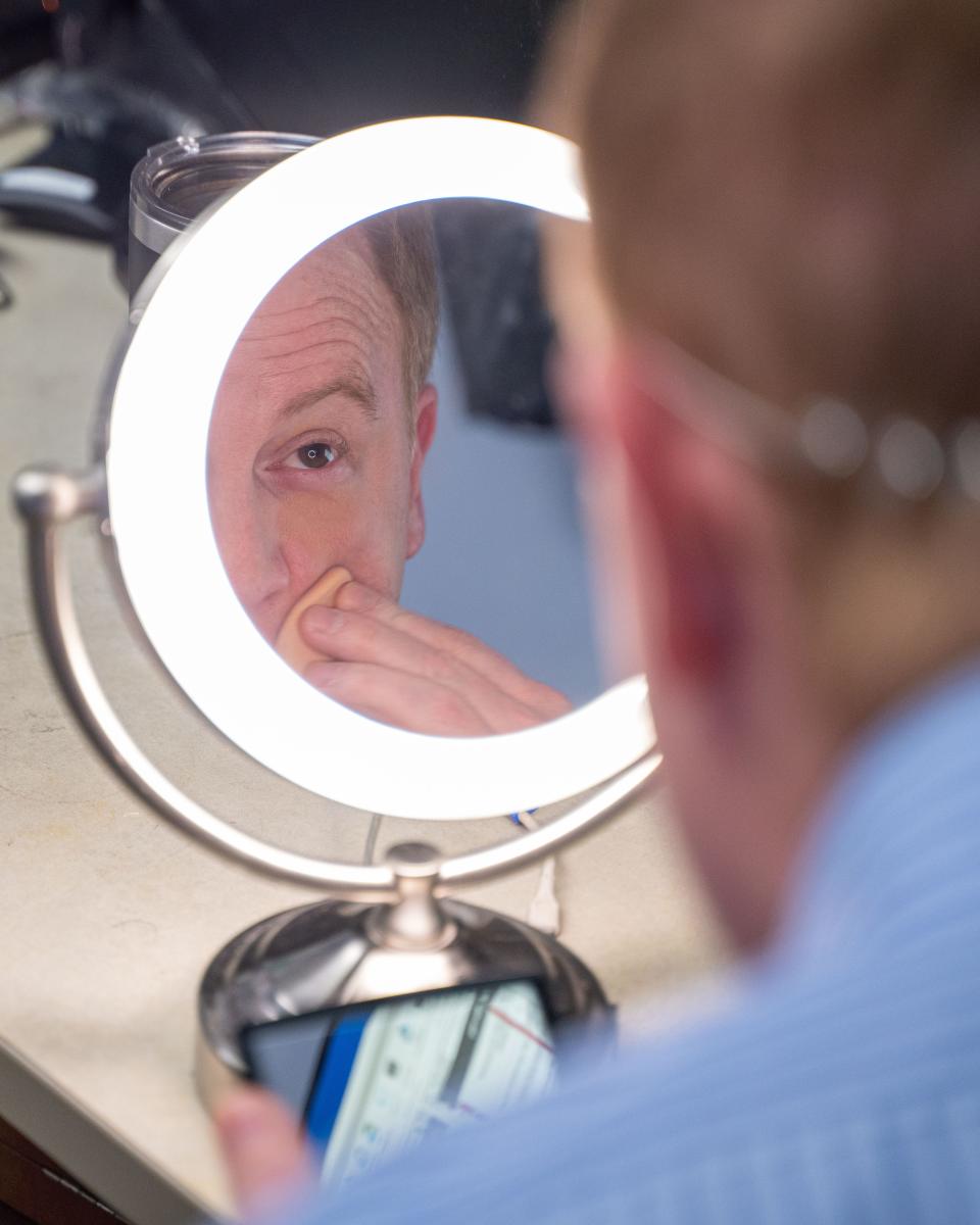 Fox 59 sports anchor Chris Hagan touches up his makeup for his broadcast Dec 10, 2023, Indianapolis, at Fox 59 Studio. Mandatory Credit: Jacob Musselman-The Indianapolis Star