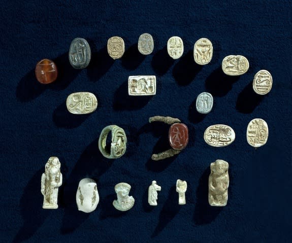 The collection of artifacts found in the cave includes faience amulets depicting Egyptian gods and scarab seals depicting Egyptian pharaohs.