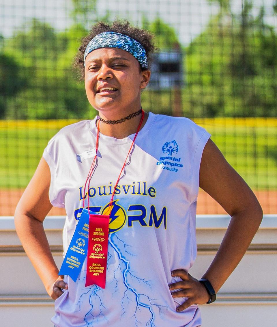 Michaela Hickerson of the Louisville Storm shows off the awards she earned after her races in the Kentucky Special Olympics Area 4 track meet at Mercy Academy in Louisville, Ky on May 14, 2022.  Hickerson will represent Team Kentucky in the Special Olympics USA games in June 2022.