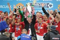 Manchester United manager Sir Alex Ferguson lifts the Barclays Premier League trophy
