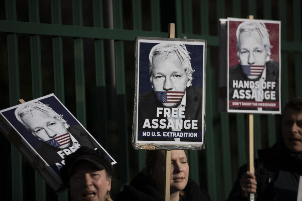 Supporters of Julian Assange hold placards as they protest on the second day of a week of opening arguments for the extradition of Wikileaks founder Julian Assange outside Belmarsh Magistrates' Court in south east London, Tuesday, Feb. 25, 2020. U.S. authorities, want to try Assange on espionage charges. A lawyer for the Americans said the Australian computer expert was an “ordinary” criminal whose publication of hundreds of thousands of secret military documents put many people at risk of torture and death. (AP Photo/Matt Dunham)