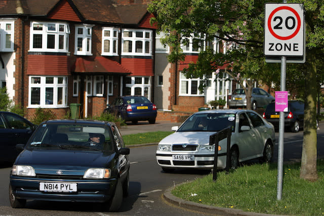 Cars pass a 20mph speed limit sign in Morden, south west London. Wide-ranging proposals to dramatically cut the number of deaths on the roads were set out by Road Safety Minister Jim Fitzpatrick today as he also confirmed a major overhaul of the driver training and testing process.