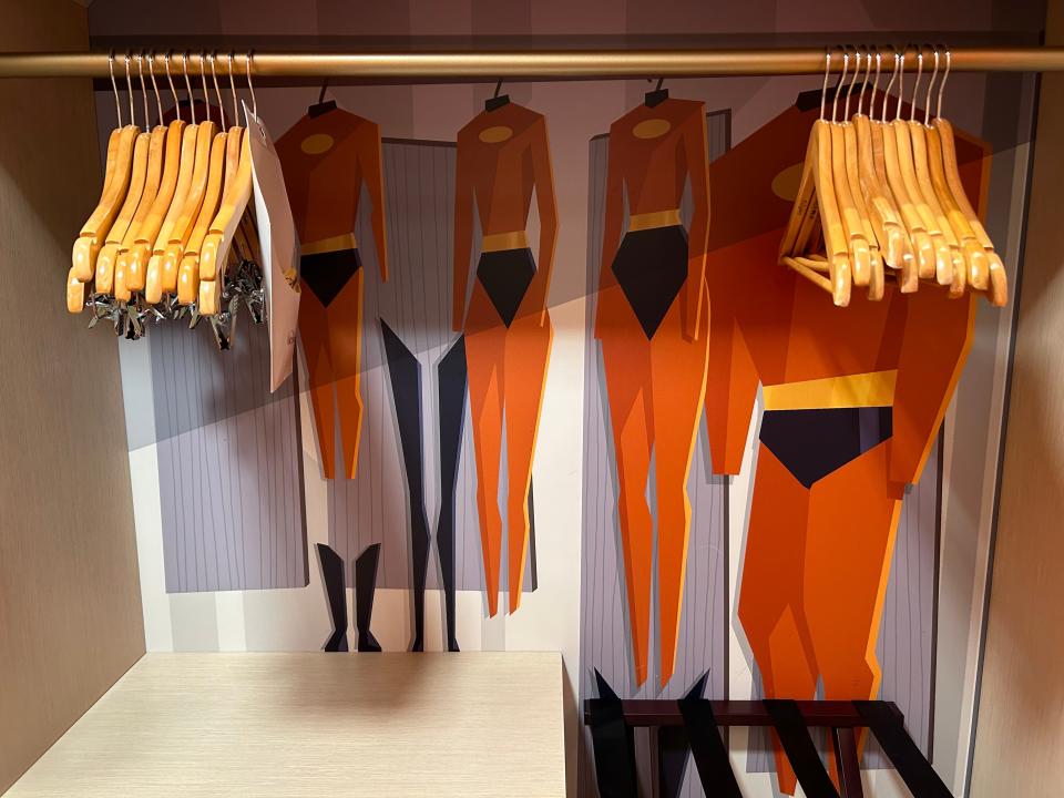 incredibles artwork in closet with hangers inside