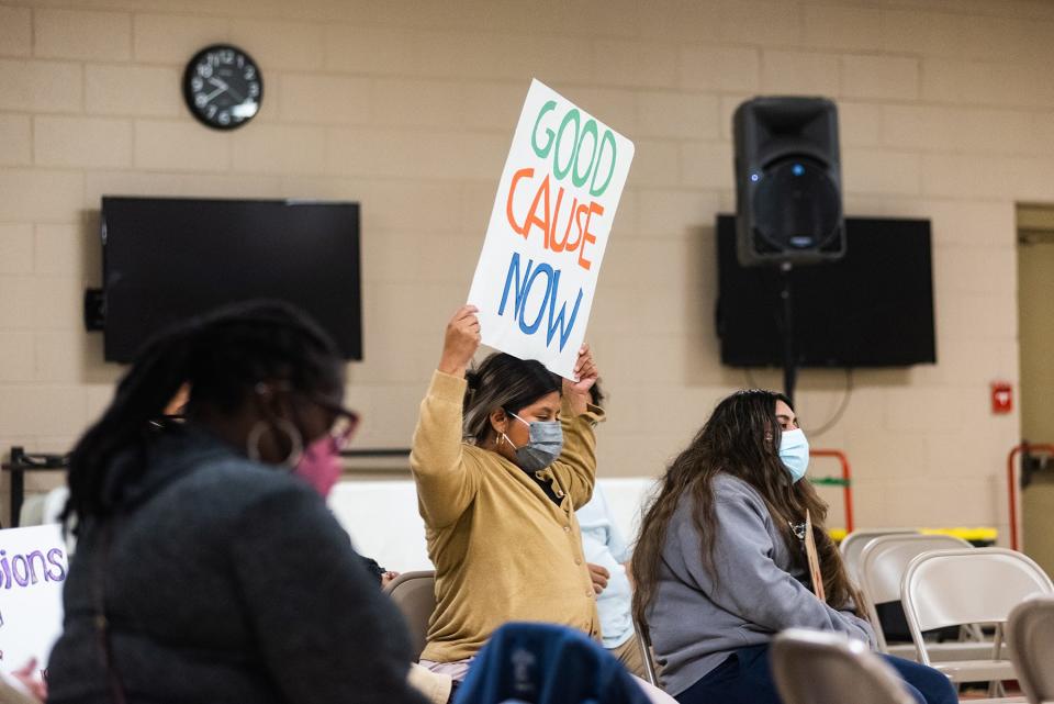 Aura Lopez Zarate of Newburgh holds up a "Good Cause Now" sign as council members discuss the legislation during the public comment on good cause eviction legislation at a Newburgh City council meeting in Newburgh, NY on Monday, October 25, 2021.