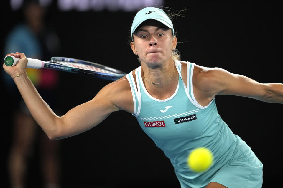 Magda Linette of Poland plays a forehand return to Aryna Sabalenka of Belarus during their semifinal match at the Australian Open tennis championship in Melbourne, Australia, Thursday, Jan. 26, 2023. (AP Photo/Aaron Favila)