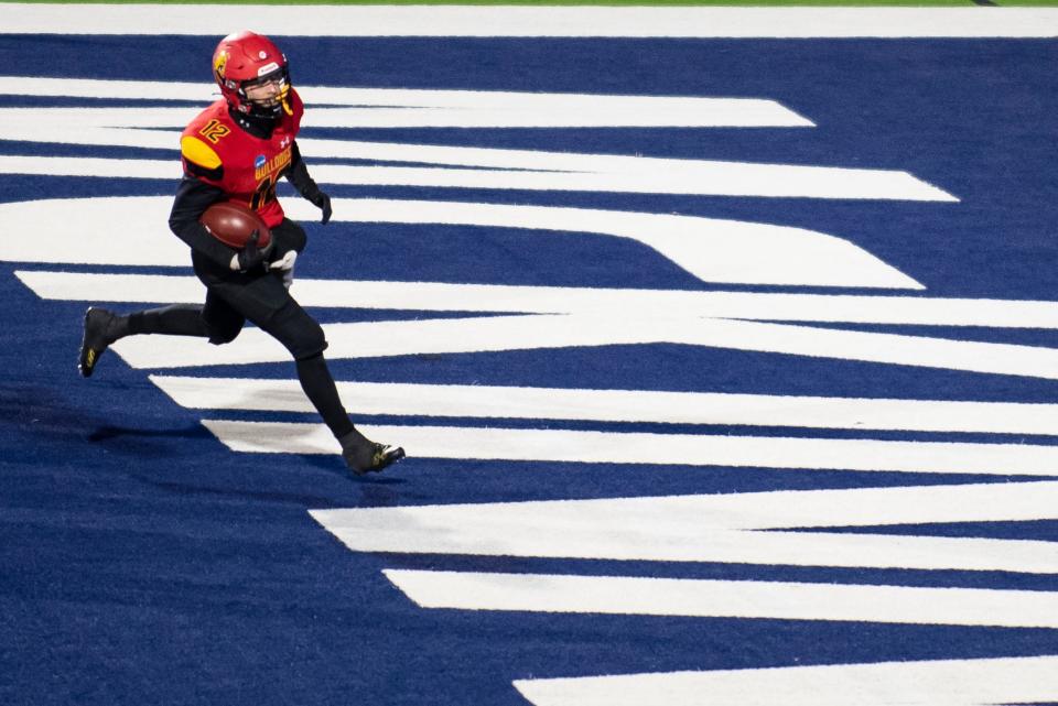 Ferris State quarterback Jared Bernhardt (12) rushes into the end zone for a touchdown in the first half of the Division II championship NCAA college football game against Valdosta State in McKinney, Texas, Saturday, Dec. 18, 2021. (AP Photo/Emil Lippe)