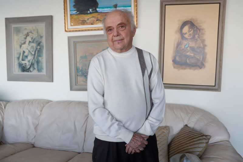 Yehuda Evron poses at his apartment in the Queens borough of New York