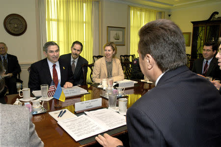 FILE PHOTO: Deputy Secretary of Defense Paul Wolfowitz hosts a Pentagon meeting next to his interpreter Peter Fedynsky, Deputy Assistant Secretary of Defense for Eurasian Policy, Mira Ricardel and Ukrainian Prime Minister Viktor Yanukovych at the Pentagon in Washington, U.S., October 9, 2003 and obtained November 13, 2018. Courtesy R.D. Ward/U.S. Department of Defense/Handout via REUTERS