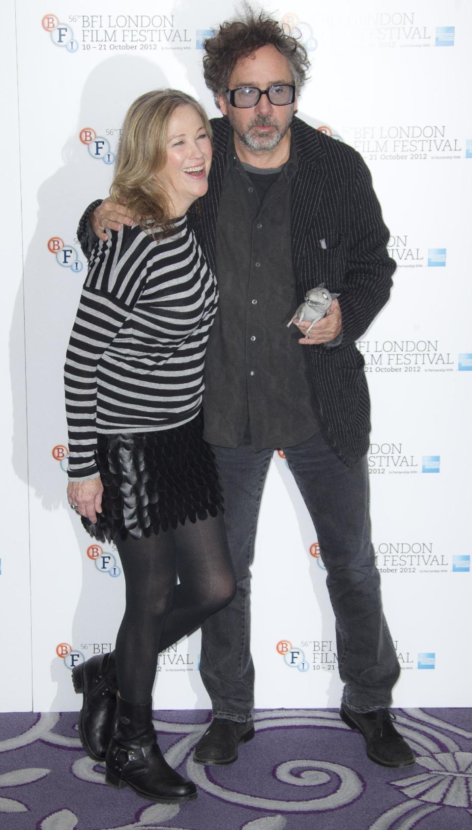 Director Tim Burton and actress Catherine O'Hara hug at a photocall for Burton's "Frankenweenie", during the London Film Festival at The Odeon, Leicester Square on Wednesday, October 10, 2012 in London, UK. (Photo by Joel Ryan/Invision/AP)