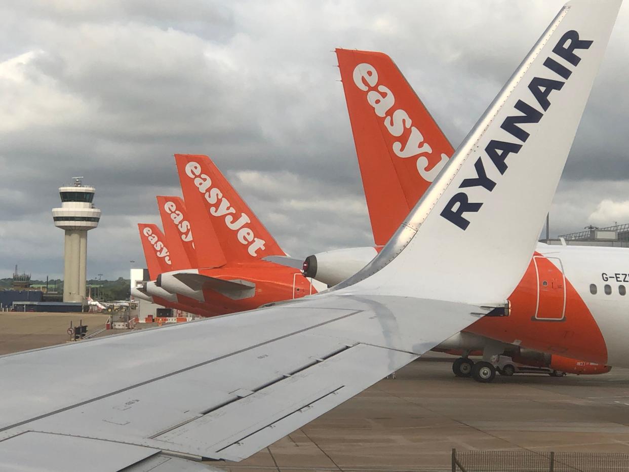 <p>Safe bets: the view from a Ryanair plane of easyJet tailfins at Gatwick airport</p> (Simon Calder)