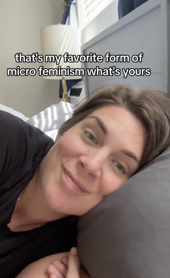 Woman resting her head on a pillow, smiling at the camera with text overlay about micro feminism