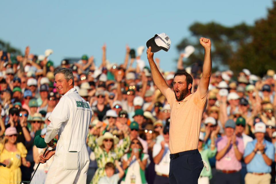 Scottie Scheffler of the United States and caddie Ted Scott celebrate on the 18th green after winning the 2024 Masters Tournament at Augusta National Golf Club on April 14, 2024 in Augusta, Georgia. / Credit: Andrew Redington/Getty Images