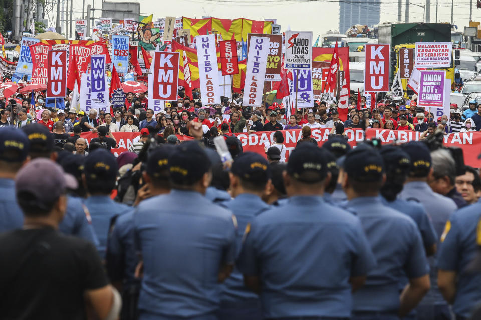 Protesters march along the main road heading to the House of Representatives in Quezon City, Philippines, Monday, July 24, 2023, ahead of the second State of the Nation Address of Philippine President Ferdinand Marcos Jr. (AP Photo/Gerard Carreon)